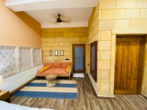 a room with a couch and a door at Hotel in Jaisalmer