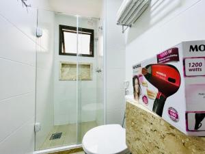 a bathroom with a shower and a toilet at Apartamento dos Sonhos na Praia dos Anjos in Arraial do Cabo
