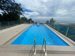 a large swimming pool with blue water at Niiora lodge in Faaa