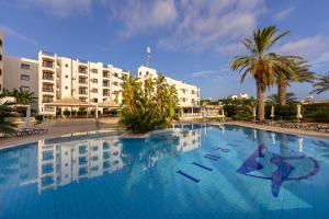 a large swimming pool in front of a hotel at Seagull Hotel Apartments in Protaras