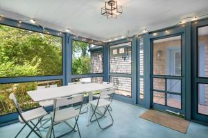 a dining room with blue walls and a white table and chairs at 78 Bucks Creek Road Chatham - Saltaire in Chatham