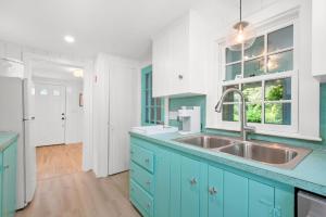 a kitchen with blue cabinets and a sink at 78 Bucks Creek Road Chatham - Saltaire in Chatham +28 photos