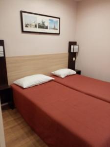 Postel nebo postele na pokoji v ubytování Brit Hotel St-Quentin/Nord