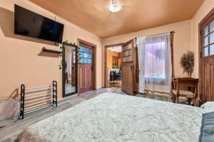a bedroom with a large bed and a flat screen tv at Charming 2-Bedroom Retreat in Lomas de Bezares in Mexico City