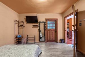 a bedroom with a bed and a tv and a door at Charming 2-Bedroom Retreat in Lomas de Bezares in Mexico City