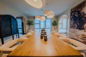 a conference room with a long wooden table and chairs at Casa Loba Luxe Apartment with pool and ocean views in Rincon +32 photos