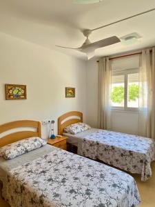 a bedroom with two beds and a window at Condado de Alhama, Jardin 11 in Alhama de Murcia