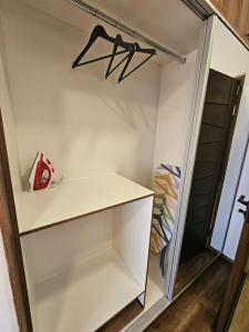 a closet with white shelves and a black door at Departamento en Cochabamba con hermosa vista in Calacala +10 photos