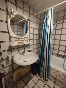 a bathroom with a sink and a mirror and a tub at Marilleva1400 Residence Albaré hotel Solaria in Marilleva