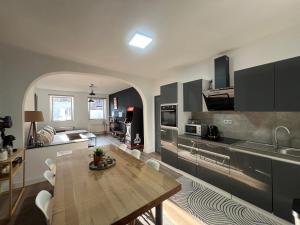 a kitchen with a table and a dining room at Appartement Verviers in Verviers