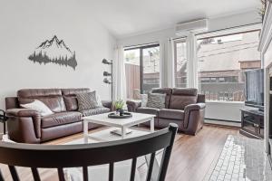 a living room with a couch and a table at Unité 26 - Ski-in Ski-out in Beaupré