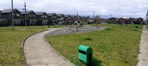 a park with a playground with a swing at Hospedaje Martín Pescador in Villarrica