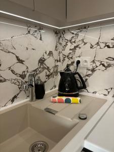 a kitchen counter with a tea kettle on a counter top at THE ONE Apartment in Tomaszów Mazowiecki +53 photos