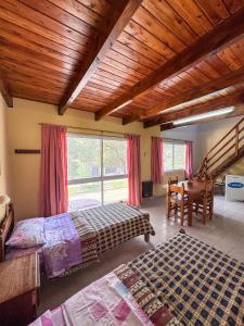a bedroom with two beds and a wooden ceiling at HColon in Colón