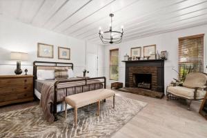 a bedroom with a bed and a fireplace at Private Retreat Burwood 8 acres Hot Tub Fire pit in Spring Hill