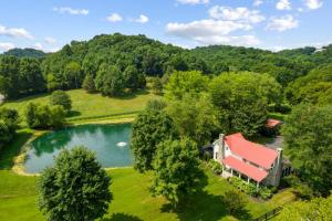 an aerial view of a house with a pond at Private Retreat Burwood 8 acres Hot Tub Fire pit in Spring Hill