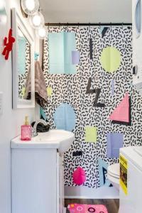 a bathroom with a toilet and a shower curtain at 90s Crib -2bed 1bath, Funky Vibe, Central Location in Murfreesboro