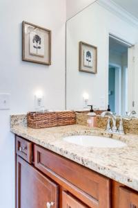 a bathroom with a sink and a large mirror at Birdsong Retreat Hot Tub Grill Fire Pit in Franklin
