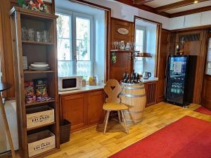 a kitchen with a bar and a wine barrel in a room at Boutique-Hotel Krone in Denzlingen