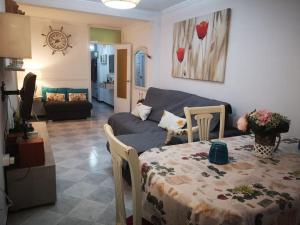 a living room with a table and a couch at Mi pisito La Maña in San Fernando