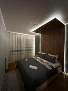 a bedroom with a large bed in a room at X apartment - Charming 1BR Retreat apartment in Pristina