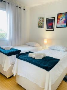 Ένα ή περισσότερα κρεβάτια σε δωμάτιο στο Conforto a 5 min do São Paulo Expo e Jardim Botânico