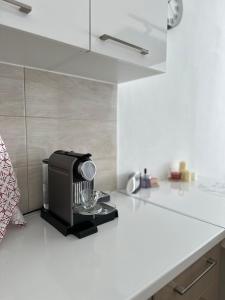 a kitchen with a blender on a counter at X apartment - Charming 1BR Retreat apartment in Pristina