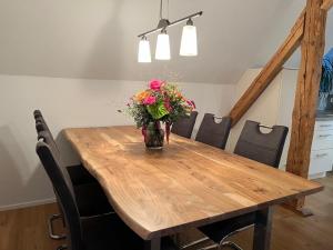a vase of flowers sitting on a wooden table at FeWo Herz im Allgäu in Lindenberg im Allgäu