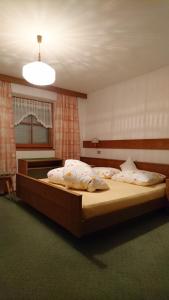 a bedroom with a large bed with pillows on it at Apartments Blumenheim in Castelrotto