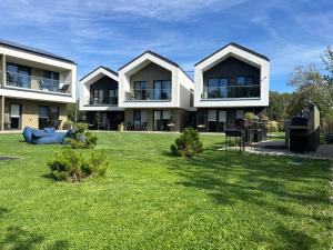 a large house with a large yard with green grass at Jūros 40 in Šventoji