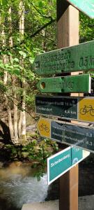 a pile of signs on a wooden pole at Gästeunterkunft Bergzauber - Frühstück möglich in Scheibenberg +1 photo