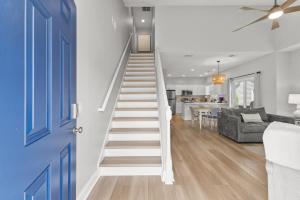a staircase in a living room with a blue door at Fairway Oaks Unit 57B in Myrtle Beach