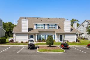 a house with a car parked in a parking lot at Fairway Oaks Unit 57B in Myrtle Beach