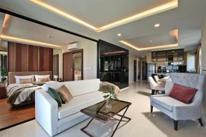 a living room with a white couch and a chair at 3bdr SeaView Apartment in Surin Beach by Capital Pro in Phuket Town