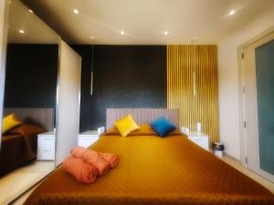 a bedroom with a large orange bed with pillows at Country View Retreat in Żabbar
