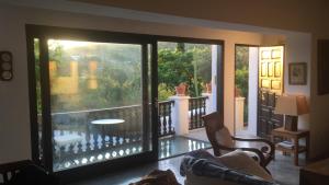 a living room with a view of a balcony at encantadora casa ibicenca in Sant Josep de sa Talaia