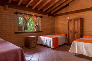 a room with two beds and a window in it at Jorullo Paradise in Puerto Vallarta