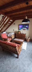 a living room with two benches and a table at Bosque Del Sur Cabañas in Ushuaia