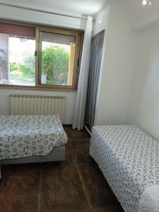 a bedroom with two beds and a window at Regina sul Mare in Terracina
