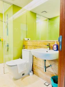 a bathroom with a sink and a toilet and a mirror at APARTMENT VorteX KLCC in Kuala Lumpur