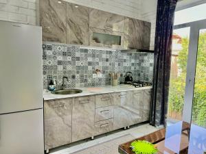 a kitchen with a sink and a refrigerator at Samdarvoza in Tashkent +86 photos