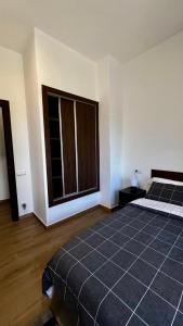 a bedroom with a bed and a large window at Apartamentos Lamata in Lamata +16 photos