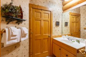 a bathroom with a sink and a mirror at Grand Superior Lodge in Castle Danger +110 photos