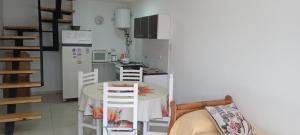 a kitchen with a table and a kitchen with a refrigerator at Luma in Bahía Blanca