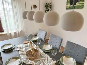 a dining room table with plates and wine glasses at Haus Eichenblick Espelkamp in Espelkamp-Mittwald +25 photos