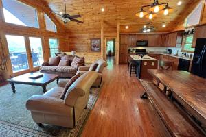 a large living room with couches and a kitchen at Smoky Mountain High in Bryson City
