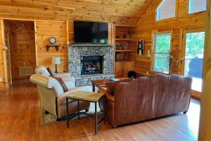 a living room with a couch and a fireplace at Smoky Mountain High in Bryson City