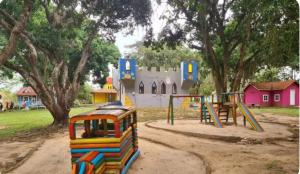 a playground in a park with a castle at Cantinho da Bell in Araruama
