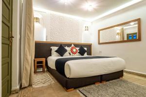 Postel nebo postele na pokoji v ubytování Riad Hamdane et SPA