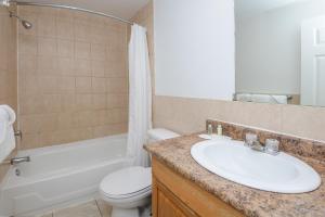 a bathroom with a sink and a toilet and a tub at Knights Inn London Ontario in London +30 photos